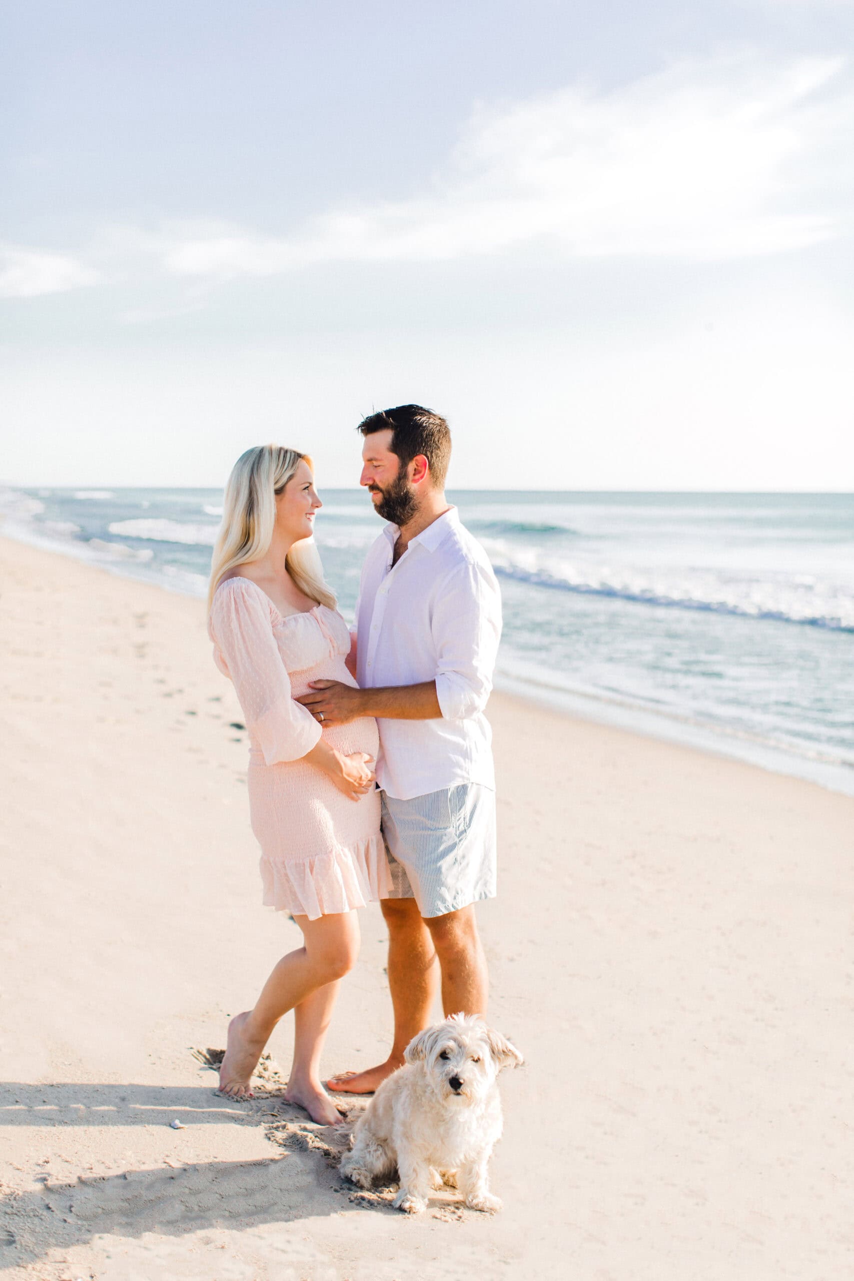 Beautiful beach engagement photography with happy couple and their pet.