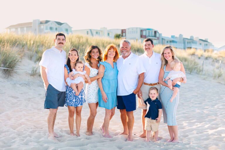 A happy multi-generational family enjoying a sunny day at the beach in Outer Banks, capturing memorable moments during a professional photo session.